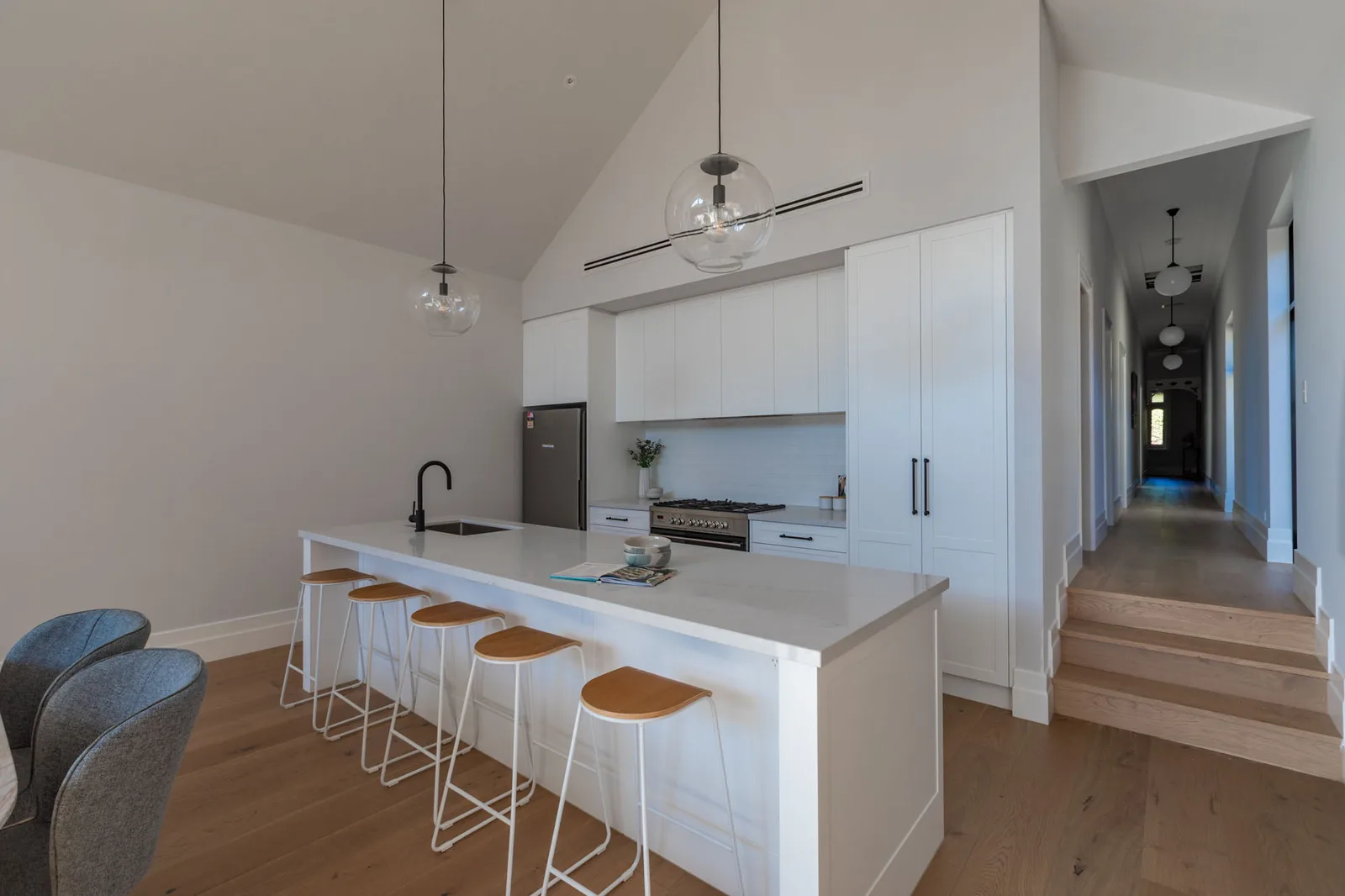 Heritage home renovation with vaulted-ceiling kitchen by Nicon Built